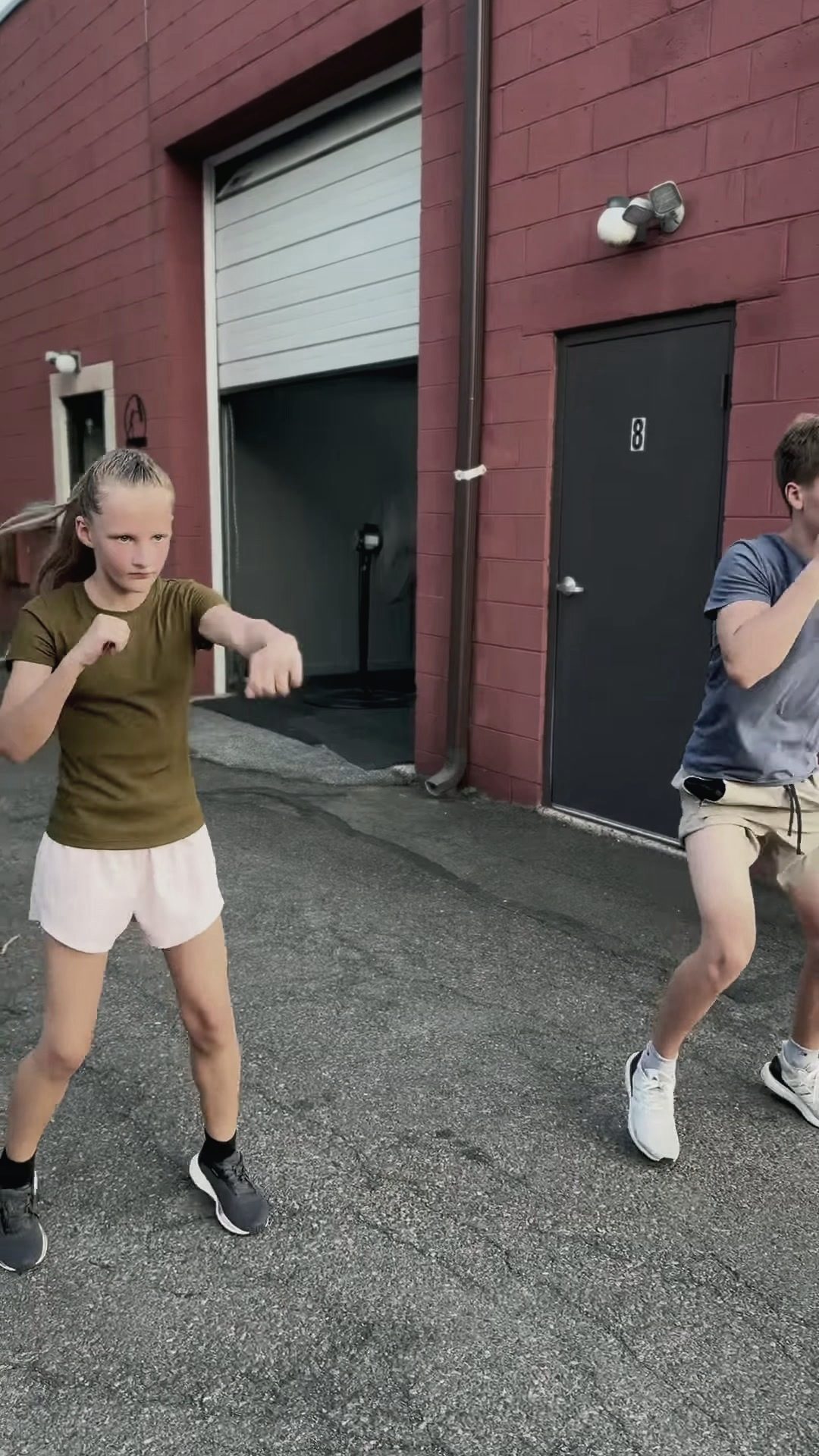 Shadowboxing drills outside the gym, unit 8 door behind