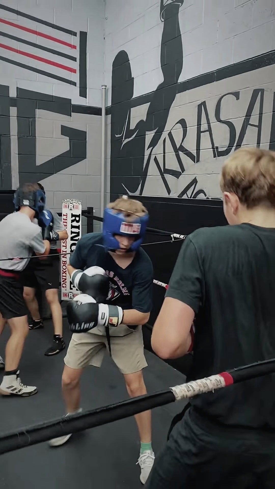Sparring in headgear by the KRASAVA mural