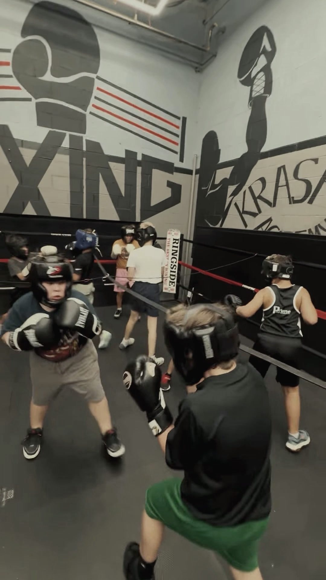 Kids' class training in the gym by the ring