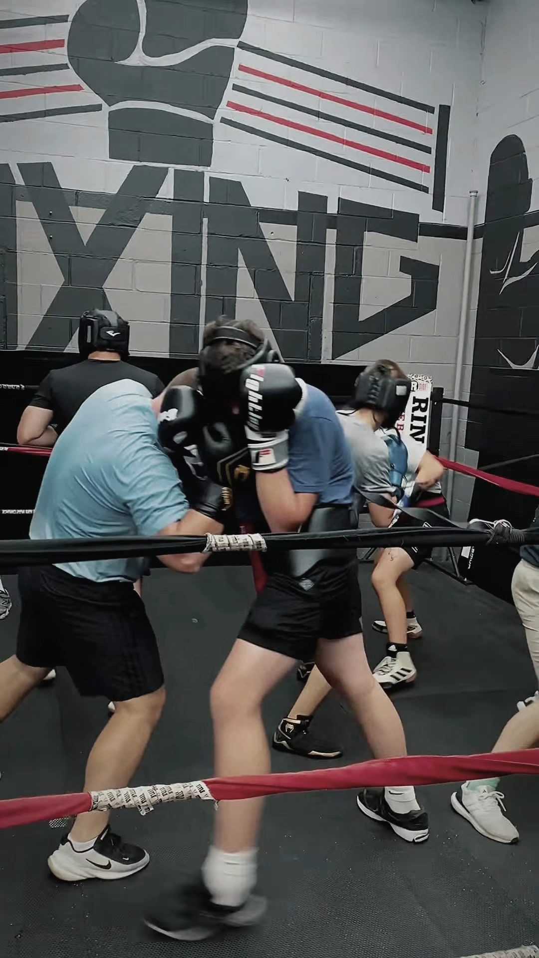 Adults sparring in headgear
